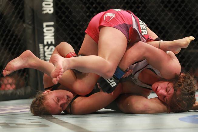 Ronda Rousey works to get an arm bar on Miesha Tate their fight at UFC 168 Saturday, Dec. 28, 2013 at the MGM Grand Garden Arena. Tate tapped out seconds later.