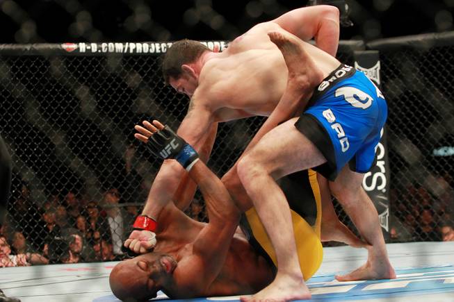 Chris Weidman throws punches at Anderson Silva during their title fight at UFC 168 Saturday, Dec. 28, 2013 at the MGM Grand Garden Arena. Weidman won by TKO after he checked a Silva kick which broke Silva's leg.