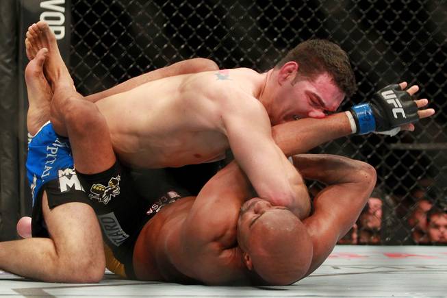 Chris Weidman hits Anderson Silva with an elbow during their middleweight title fight at UFC 168 Saturday, Dec. 28, 2013 at the MGM Grand Garden Arena. Weidman won by TKO after he checked a Silva kick which broke Silva's leg.