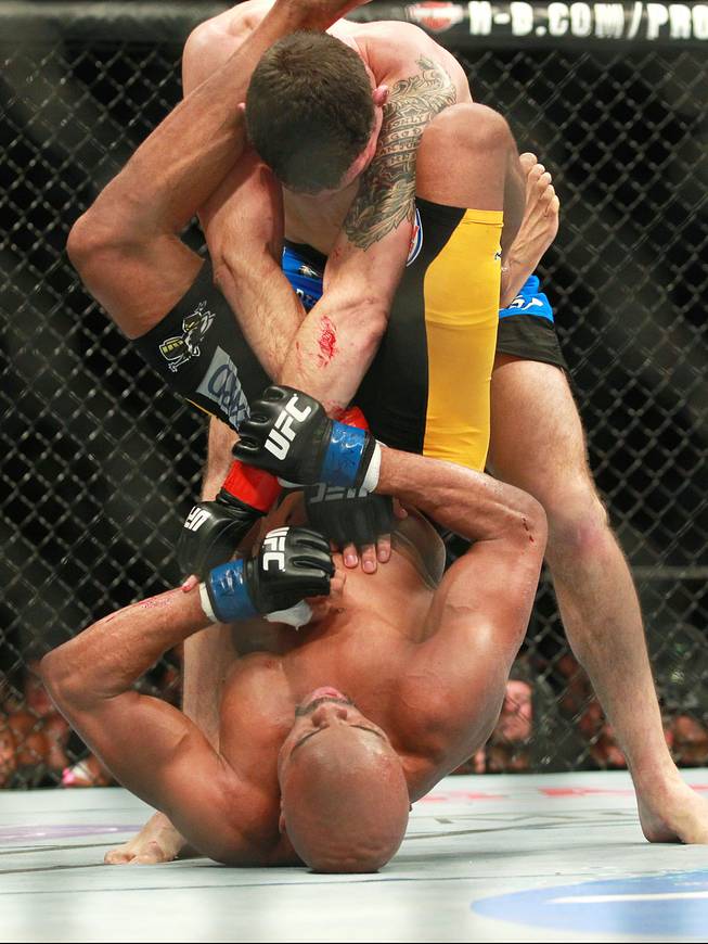 Chris Weidman escapes from Anderson Silva during their fight at UFC 168 Saturday, Dec. 28, 2013 at the MGM Grand Garden Arena. Weidman won by TKO after he checked a Silva kick which broke Silva's leg.
