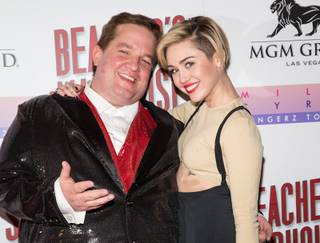 Miley Cyrus, with Jeff Beacher, hosts the opening of Beacher’s Madhouse on Friday, Dec. 27, 2013, at MGM Grand in Las Vegas.