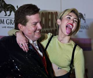 Jeff Beacher and Miley Cyrus joke around on the Red Carpet at the opening of Beacher's Madhouse MGM Grand Hotel & Casino on Friday, Dec. 27, 2013.
