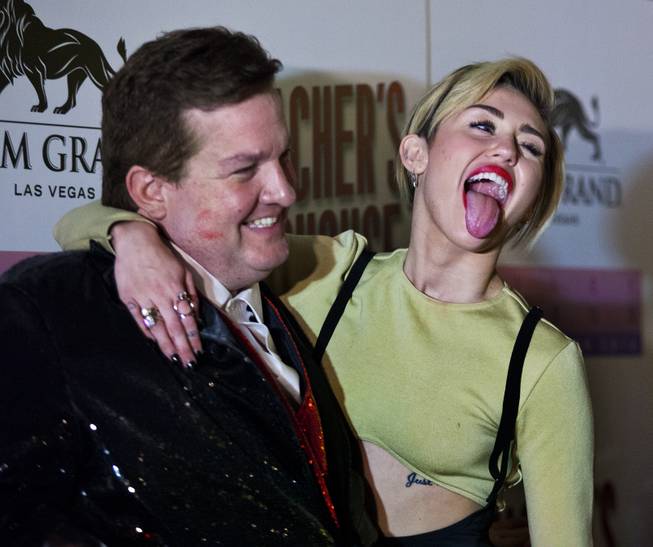 Jeff Beacher and Miley Cyrus joke around on the Red Carpet at the opening of Beacher's Madhouse MGM Grand Hotel & Casino on Friday, Dec. 27, 2013.