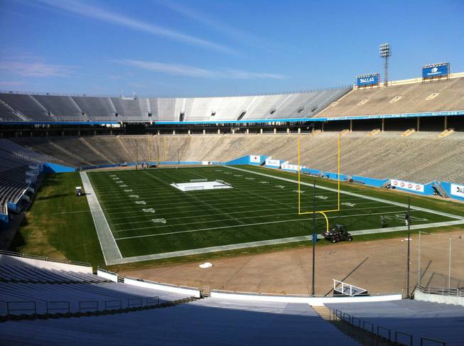 The field at Cotton Bowl Stadium in Dallas undergoes a paint job four days before UNLV and North Texas will play there on Jan. 1 in the Heart of Dallas Bowl.