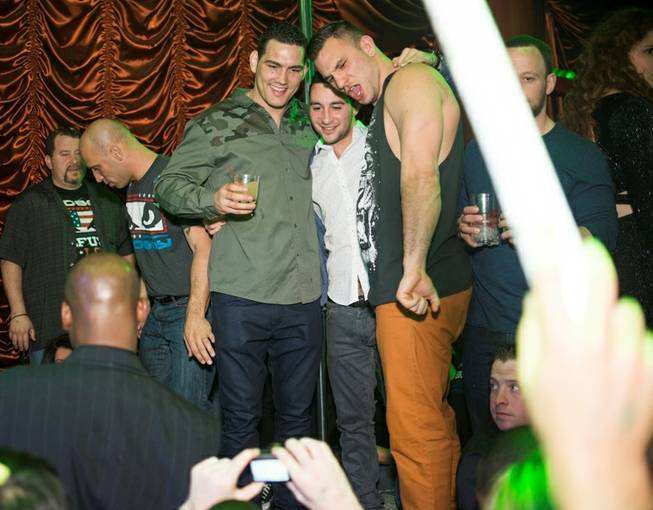 Chris Weidman, in the green camoflage shirt, celebrates his UFC ...