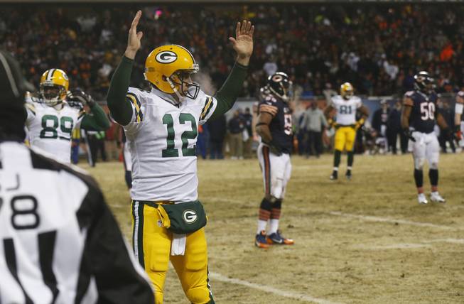 Green Bay Packers quarterback Aaron Rodgers reacts after Packers' wide receiver Jarrett Boykin picked up Rodgers' fumble and ran into the end zone for a touchdown during the first half of a game against the Chicago Bears on Sunday, Dec. 29, 2013, in Chicago.