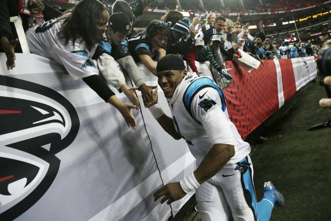 Carolina Panthers quarterback Cam Newton greets fans after the second half of an NFL football game against the Atlanta Falcons, Sunday, Dec. 29, 2013, in Atlanta. The Carolina Panthers won 21-20.
