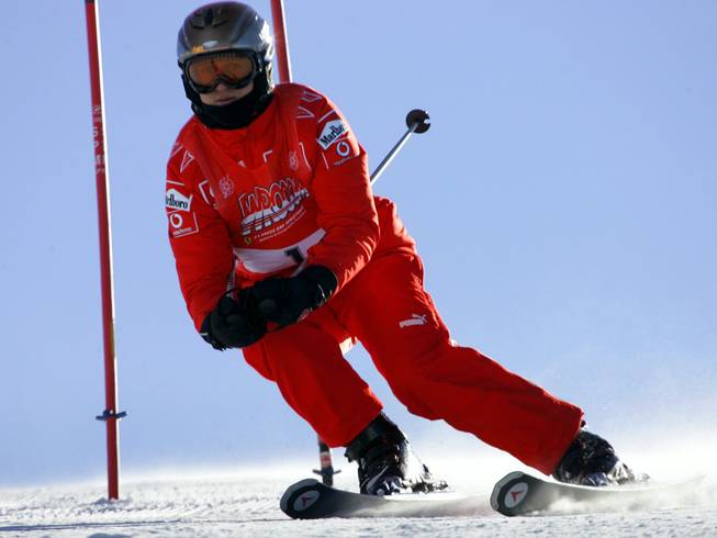 In this Friday, Jan. 13, 2006, file photo, Ferrari driver Michael Schumacher of Germany speeds down a course in Madonna di Campiglio, Italy. 