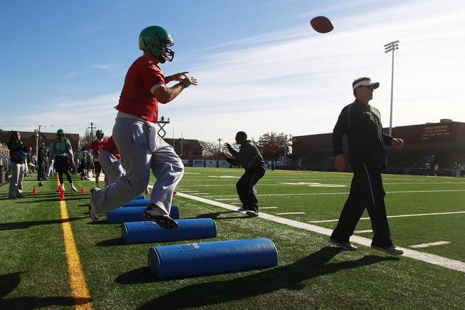 Quarterbacks run through drills during the North Texas practice for the Heart of Dallas Bowl Monday, Dec. 30, 2013 at Highland Park High School in Dallas.