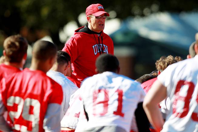 Coach Bobby Hauck talks to his team during UNLV's practice on the campus of Southern Methodist University for the Heart of Dallas Bowl on Monday, Dec. 30, 2013, in Dallas.