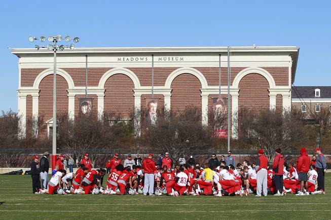 The UNLV football team huddles during practice on the campus of Southern Methodist University for the Heart of Dallas Bowl Monday, Dec. 30, 2013 in Dallas.