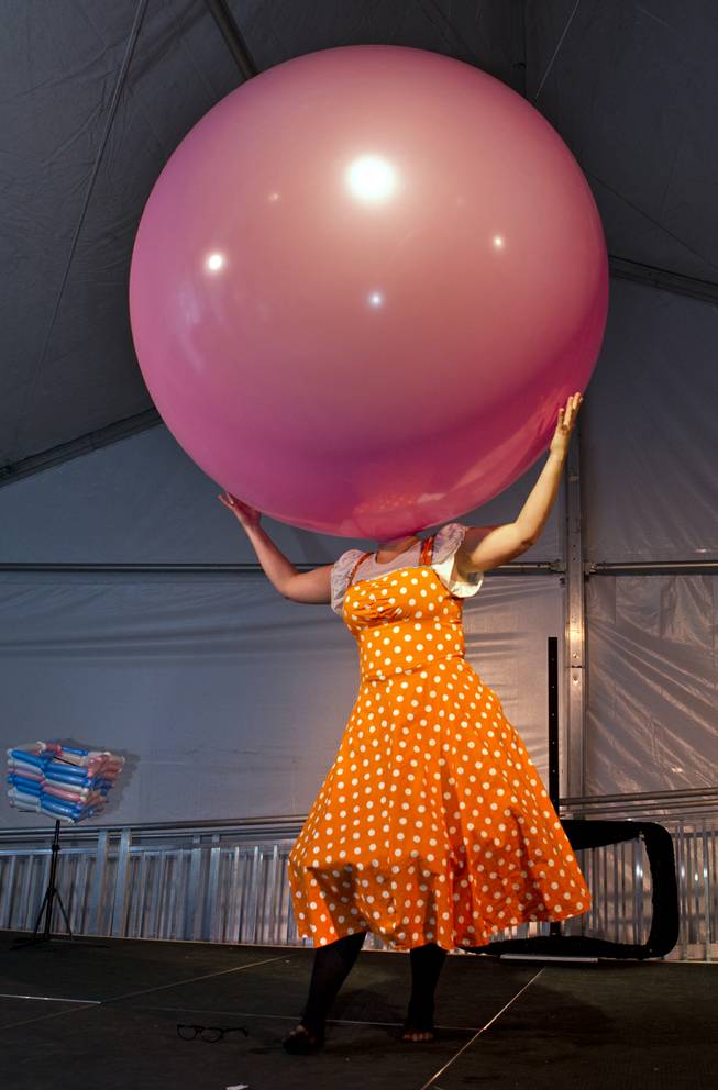 Tawney Bubbles covers he head with a giant balloon during her unique act for a family variety show in the Magical Forest at Opportunity Village on Monday , Dec. 30, 2013. L.E. Baskow