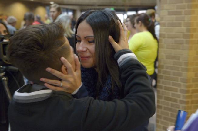 Angela Marinez, left, embraces her wife Monique Lobato in a kiss after being married in the lobby of the Salt Lake County offices on Monday, Dec. 23, 2013. 