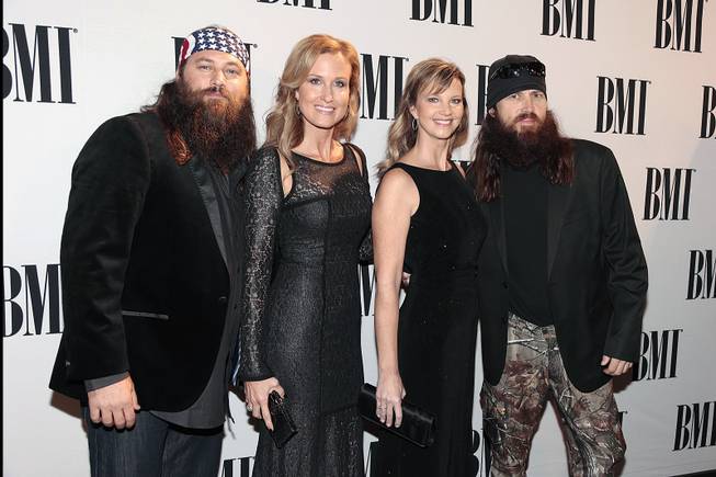 Willie Robertson, his wife Korie Robertson, Missy Robertson and her husband Jase Robertson of “Duck Dynasty” arrive at the BMI Country Awards on Nov. 5, 2013, in Nashville. 