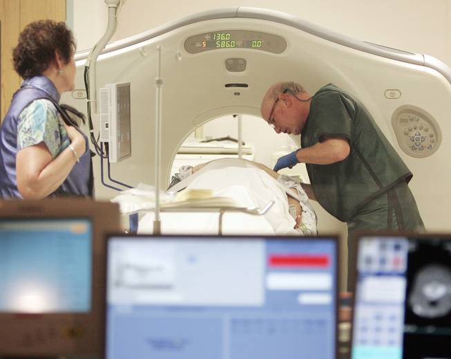 In this June 3, 2010, file photo, Dr. Steven Birnbaum works with a patient in a CT scanner at Southern New Hampshire Medical Center in Nashua, N.H.