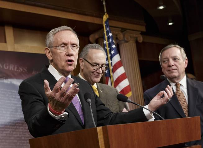 From left, Senate Majority Leader Harry Reid, D-Nev., Sen. Chuck Schumer, D-N.Y., and Senate Majority Whip Dick Durbin, D-Ill., talk to reporters about the final work of the Senate as their legislative year nears to a close, at the Capitol in Washington, Thursday, Dec. 19, 2013.