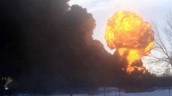 In this image made from a video provided by Darrin Rademacher, a fireball goes up at the site of an oil train derailment Monday, Dec 30, 2013, in Casselton, N.D. Several explosions were reported as some cars on the mile-long train caught fire.