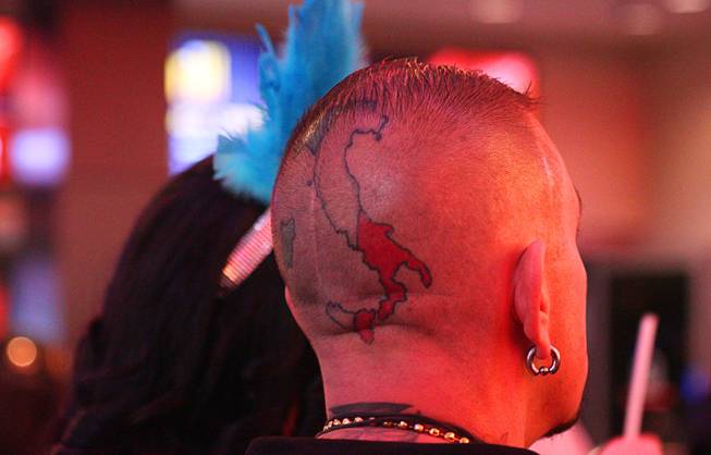 A man with a head tattoo is shown during New Year's Eve festivities at the Fremont Street Experience in downtown Las Vegas Tuesday, Dec. 31, 2013. An estimated 335,000 tourists were expected to visit Las Vegas to celebrate the new year.