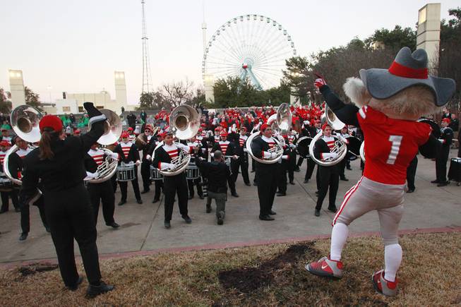 Hey Reb helps direct the UNLV band in the school's fight song during a pep rally for the Heart of Dallas Bowl Tuesday, Dec. 31, 2013 at the state fairgrounds near the Cotton Bowl in Dallas.