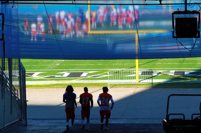 Players head to the field for a closed walk through after the UNLV football team had their team photo taken for the Heart of Dallas Bowl Tuesday, Dec. 31, 2013 at the Cotton Bowl in Dallas.