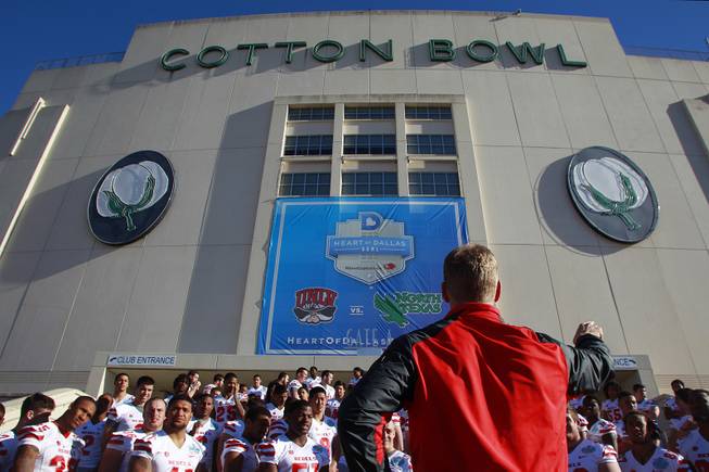 UNLV head coach Bobby Hauck gets his football team lined up for their team photo before the Heart of Dallas Bowl Tuesday, Dec. 31, 2013 at the Cotton Bowl in Dallas.