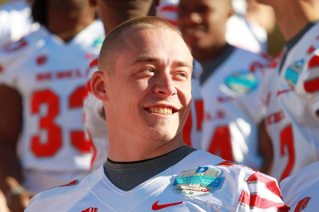 Linebacker Max Ehlert smiles as the UNLV football team gets ready to have their team photo taken for the Heart of Dallas Bowl Tuesday, Dec. 31, 2013 at the Cotton Bowl in Dallas.