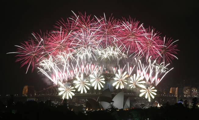Fireworks explode over the Harbour Bridge and the Opera House during New Year's Eve celebrations in Sydney, Australia, Wednesday, Jan. 1, 2014.
