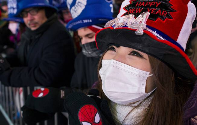 Hiromi Matsumoto of Japan watches festivities on Times Square as she takes part in New Year's Eve celebrations in New York, Tuesday, Dec. 31, 2013. 