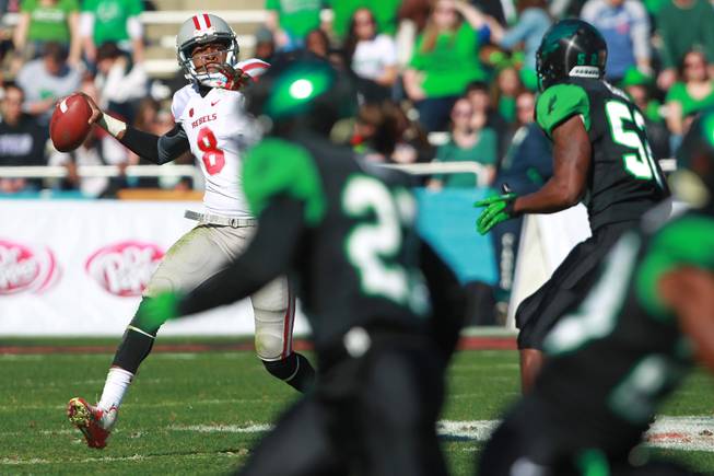 UNLV quarterback Caleb Herring looks for his receiver during the first half of the Heart of Dallas Bowl against North Texas Wednesday, Jan. 1, 2014 the Cotton Bowl in Dallas.