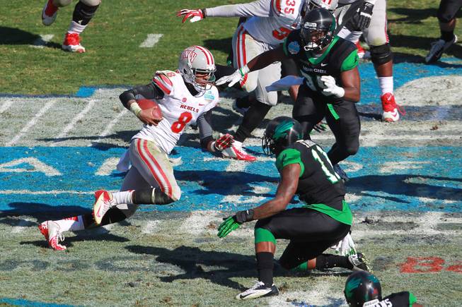 UNLV quarterback Caleb Herring heads for a hole in the North Texas defense during the first half of the Heart of Dallas Bowl Wednesday, Jan. 1, 2014 the Cotton Bowl in Dallas.