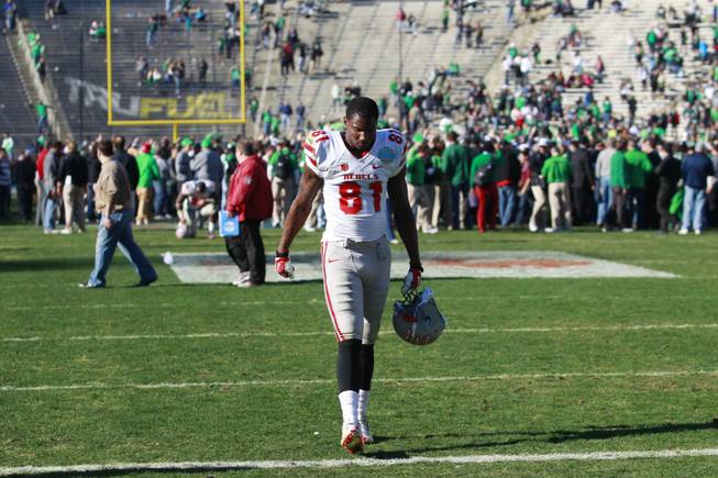 UNLV wide receiver Devante Davis walks off the field as North Texas fans celebrate after the Heart of Dallas Bowl Wednesday, Jan. 1, 2014 at the Cotton Bowl in Dallas. North Texas won 36-14.