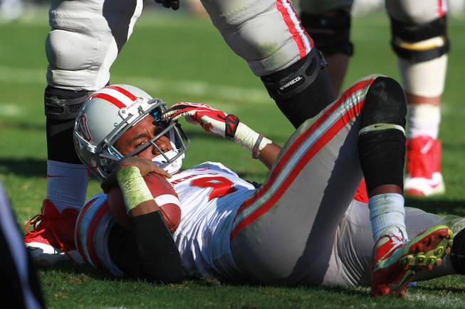 UNLV quarterback Caleb Herring lays on the ground after being sacked by North Texas during the Heart of Dallas Bowl Wednesday, Jan. 1, 2014 at the Cotton Bowl in Dallas. North Texas won 36-14.