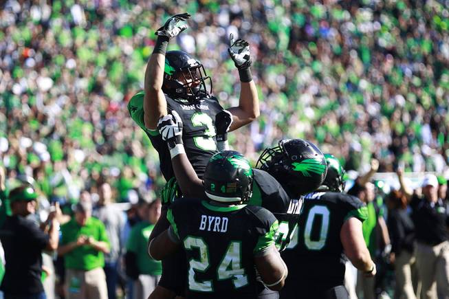 North Texas wide receiver Brelan Chancellor is lifted up after scoring a touchdown against UNLV during the Heart of Dallas Bowl Wednesday, Jan. 1, 2014 at the Cotton Bowl in Dallas. North Texas won 36-14.