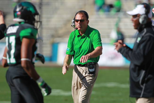 North Texas head coach Dan McCarney greets his players as they come off the field during the Heart of Dallas Bowl Wednesday, Jan. 1, 2014 at the Cotton Bowl in Dallas. North Texas won 36-14.