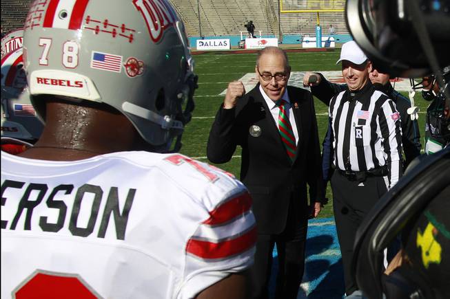Outgoing UNLV president and incoming North Texas president Neal Smatresk flips the game coin before the Heart of Dallas Bowl game between the two teams Wednesday, Jan. 1, 2014 at the Cotton Bowl in Dallas. North Texas won 36-14.