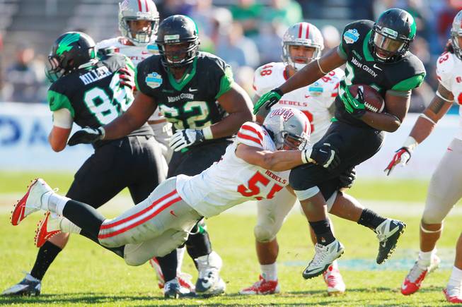 UNLV linebacker Tau Lotulelei tackles North Texas running back Brendin Byrd during the Heart of Dallas Bowl Wednesday, Jan. 1, 2014 at the Cotton Bowl in Dallas. North Texas won 36-14.