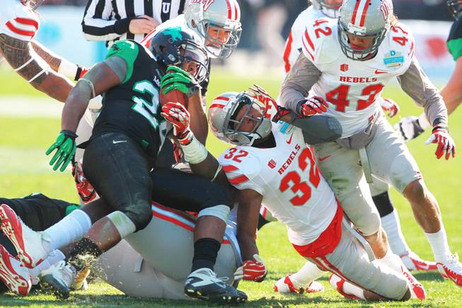 The UNLV defense stops North Texas running back Brendin Byrd during the Heart of Dallas Bowl Wednesday, Jan. 1, 2014 at the Cotton Bowl in Dallas. North Texas won 36-14.