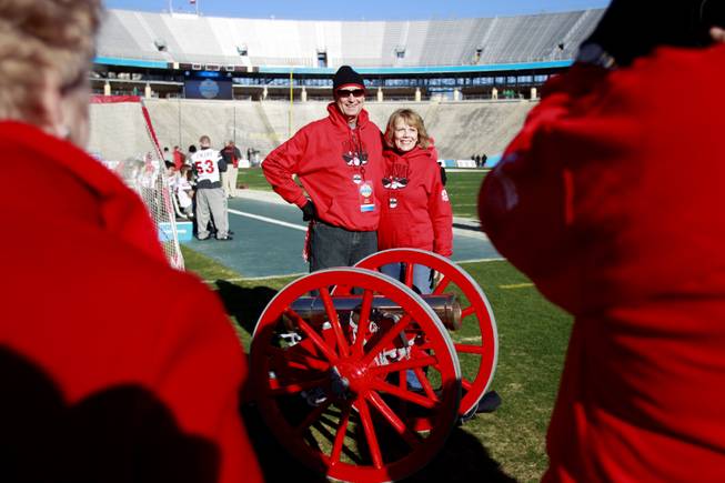 Sheldon and Sharon Wright, from Albuquerque, have their photo taken with the Fremont Cannon before the Heart of Dallas Bowl Wednesday, Jan. 1, 2014 the Cotton Bowl in Dallas. Sheldon is a 1966 graduate of UNLV.