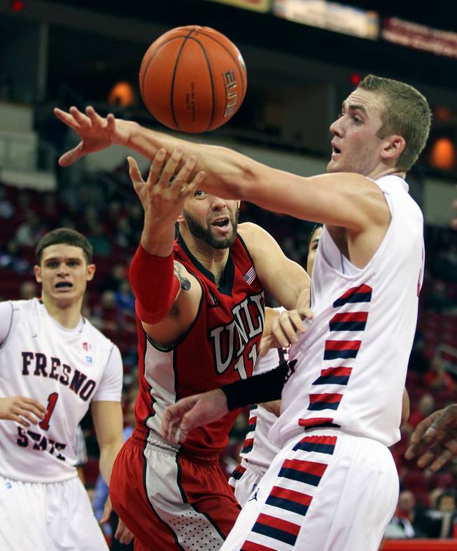 UNLV's Carlos Lopez-Sosa, left, tries to grab a rebound from Fresno State's Tanner Giddings in the first half of a NCAA college basketball game in Fresno, Calif., Wednesday, Jan. 1, 2014.