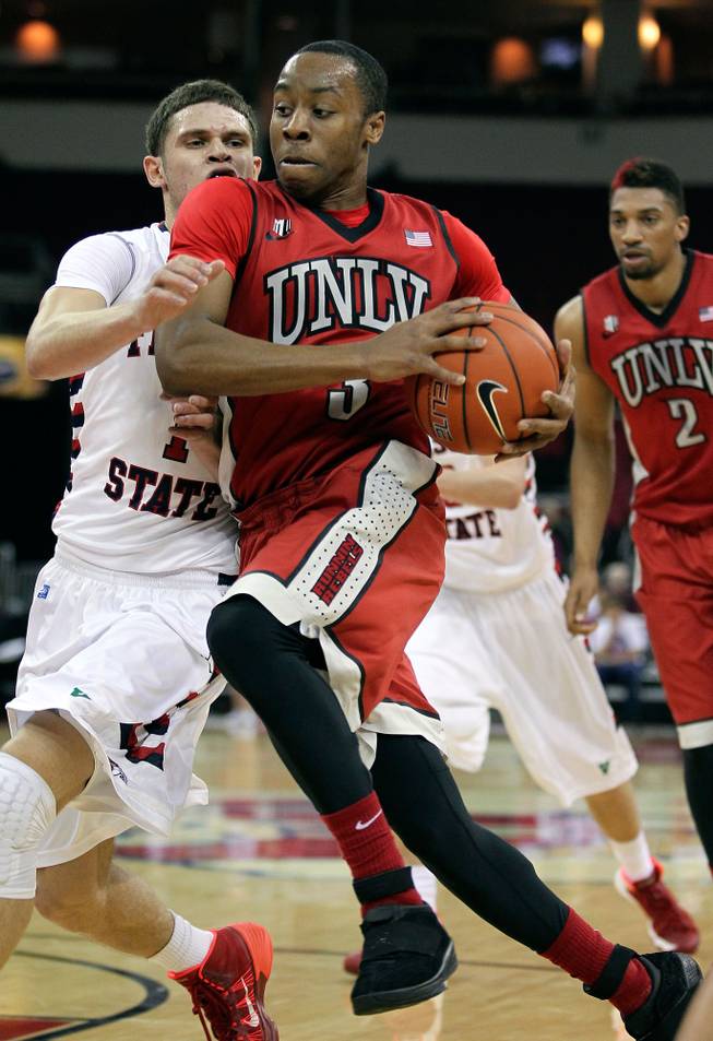 UNLV's Kevin Olekaibe, right, drives on Fresno State's Tyler Johnson in the first half of a NCAA college basketball game in Fresno, Calif., Wednesday, Jan. 1, 2014.