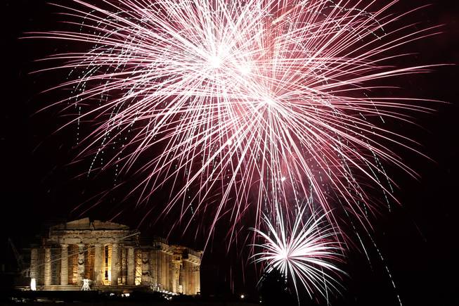 Fireworks explode over the ancient Parthenon temple at the Acropolis Hill  during the New Year's Eve celebrations in Athens, on Wednesday, Jan. 1, 2014. 