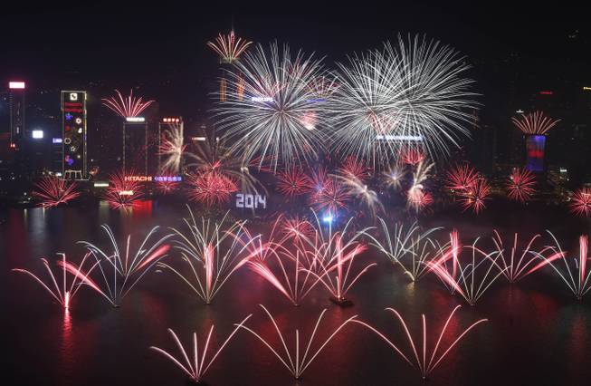 Fireworks explode at the Hong Kong Convention and Exhibition Centre over the Victoria Harbor during New Year's Eve to celebrate the start of 2014 in Hong Kong, Wednesday, Jan. 1, 2014.