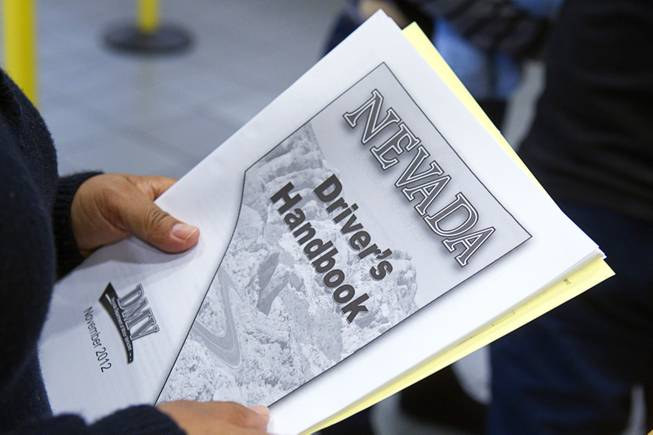 A woman holds a Nevada Driver’s Handbook at the Department of Motor Vehicles office Thursday, Jan. 2, 2014, on East Sahara Avenue.