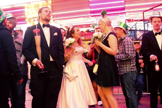 Noel Schermann, bride, celebrates her marriage with her friends during New Years Eve festivities at the Fremont Street Experience in downtown Las Vegas, Dec. 31, 2013. An estimated 335,000 tourists were expected to visit Las Vegas to celebrate the new year.