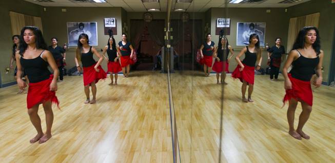 A hula workout class at the Self Quest Institute Dance Studio is reflected in a mirror on Friday, Jan. 3, 2014.