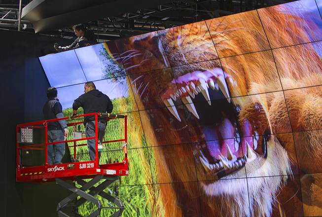 Technicians work on a LG Electronics 3-D video wall in preparation for the 2014 Consumer Electronics Show (CES) at the Las Vegas Convention Center Saturday, Jan. 4, 2014.