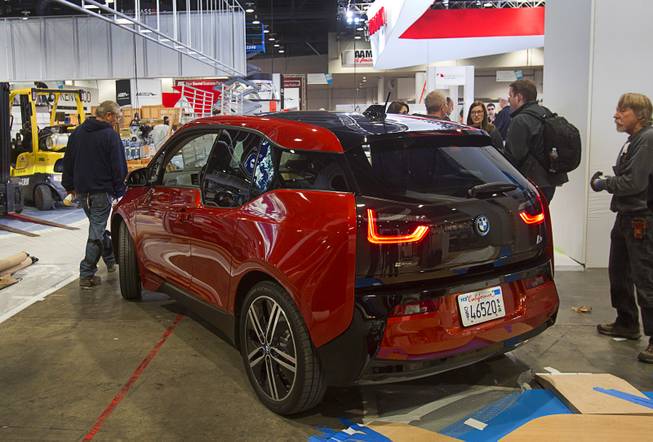 A BMW i3 electric vehicle is prepared for a display during set up for the 2014 Consumer Electronics Show (CES) at the Las Vegas Convention Center Saturday, Jan. 4, 2014.