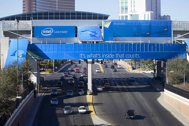 Traffic passes under a monorail station covered with an Intel wrap for the 2014 Consumer Electronics Show (CES) near the Las Vegas Convention Center Saturday, Jan. 4, 2014.