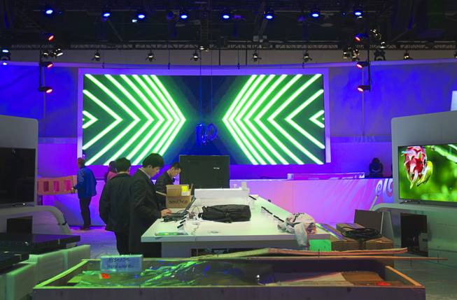 Hisense technicians set up a display in preparation for the 2014 Consumer Electronics Show (CES) at the Las Vegas Convention Center Saturday, Jan. 4, 2014.
