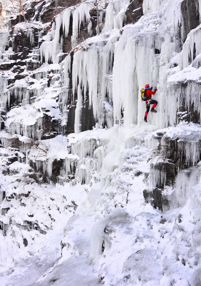 Ice climber Howie Mievogel uses ice tools and crampons to ascend a frozen waterfall on the cliffs in Riegelsville, Pa. near the Delaware River,  Saturday, Jan. 4, 2014. Below zero temperatures have brought ice climbers out of hiding the past few days.